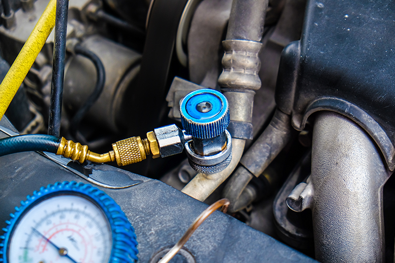 Young hispanic man smelling bad aroma sitting on car at street