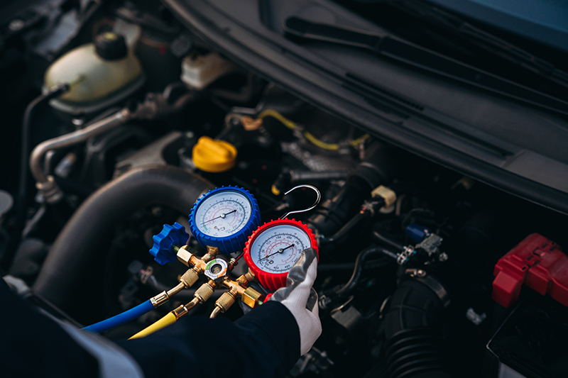 Young hispanic man smelling bad aroma sitting on car at street